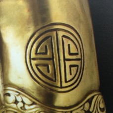 Statue of Buddha, geometrically derived cross on the arm